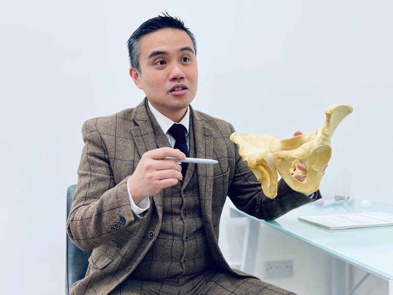 Professor Lee explaining joint anatomy during a consultation